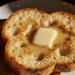 Close-up of English muffin with butter melting in the nooks and crannies